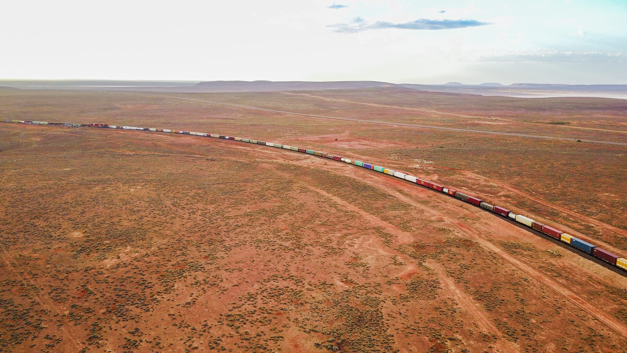 Aerial view of the freight train moving along the farmland, North Star, NSW.;